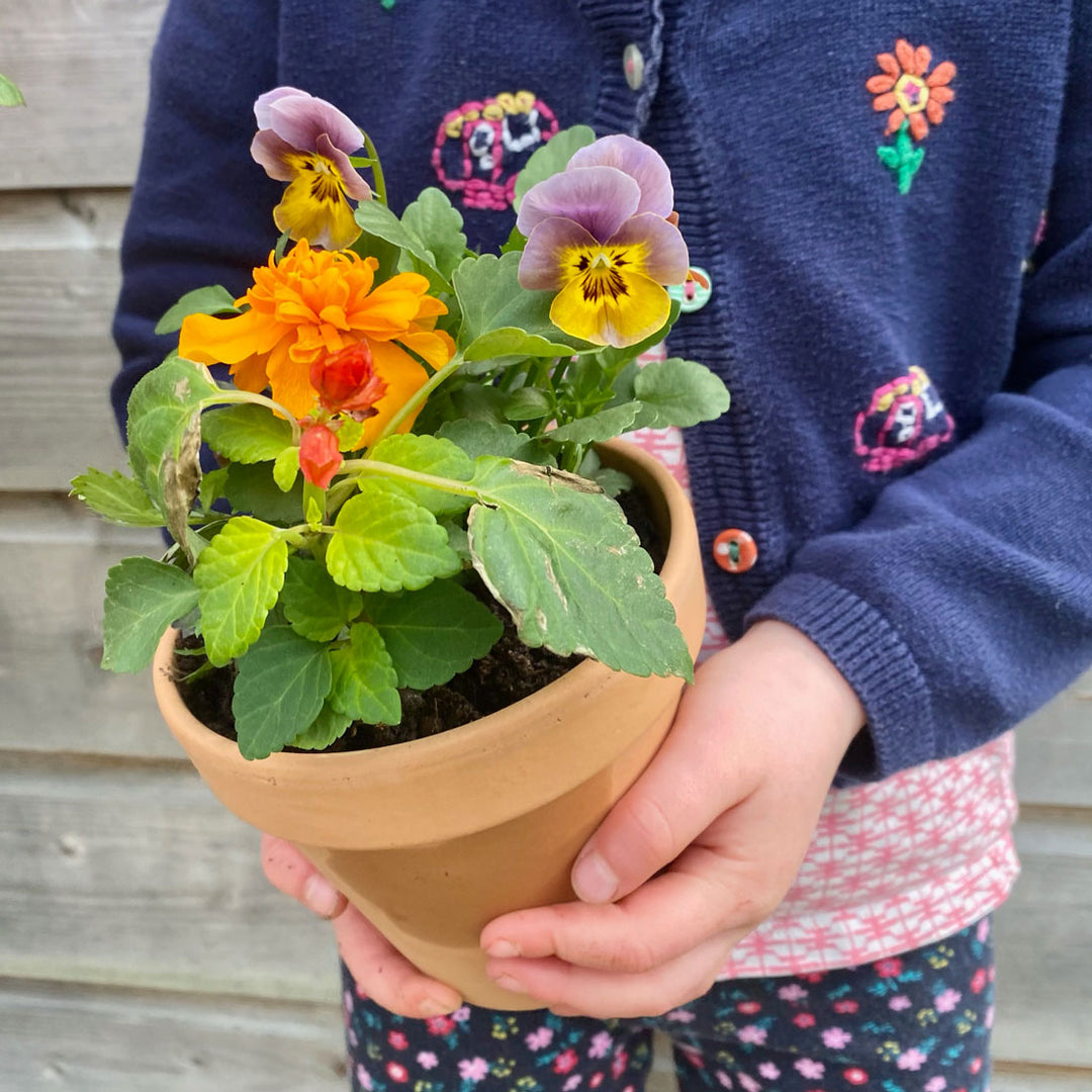 Kid holding PlantGift pot